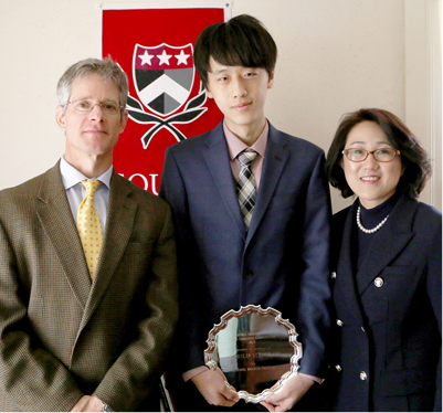 HEAD OF SCHOOL ANDREW VADNAIS, TAEK GI WITH HIS AWARD, AND DR. LEE.